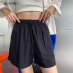 Woman wearing shorts with material linen